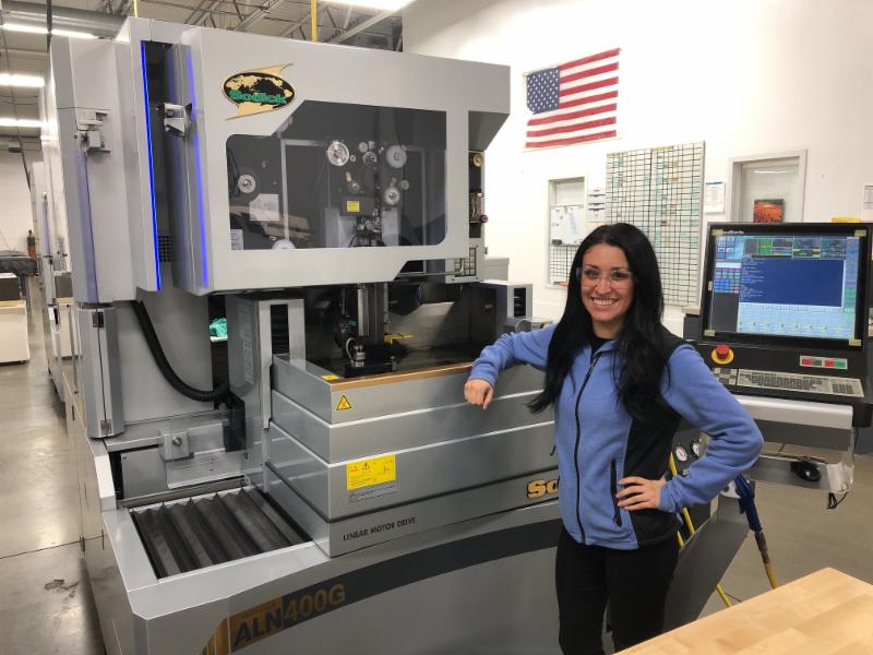 Employee standing with machinery