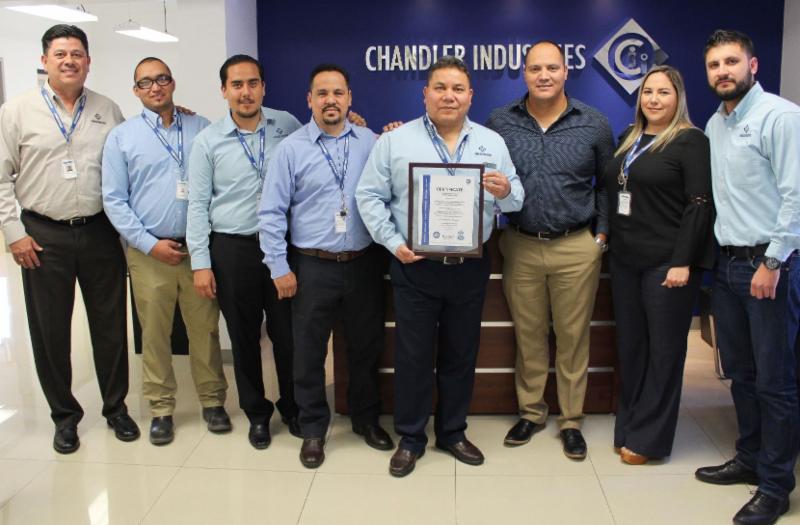 Employees standing with certification